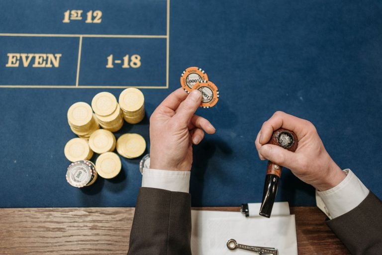 Overhead view of a casino table with poker chips and a tobacco pipe, depicting a gambling scene. — Get the Ultimate Roblox Ga
