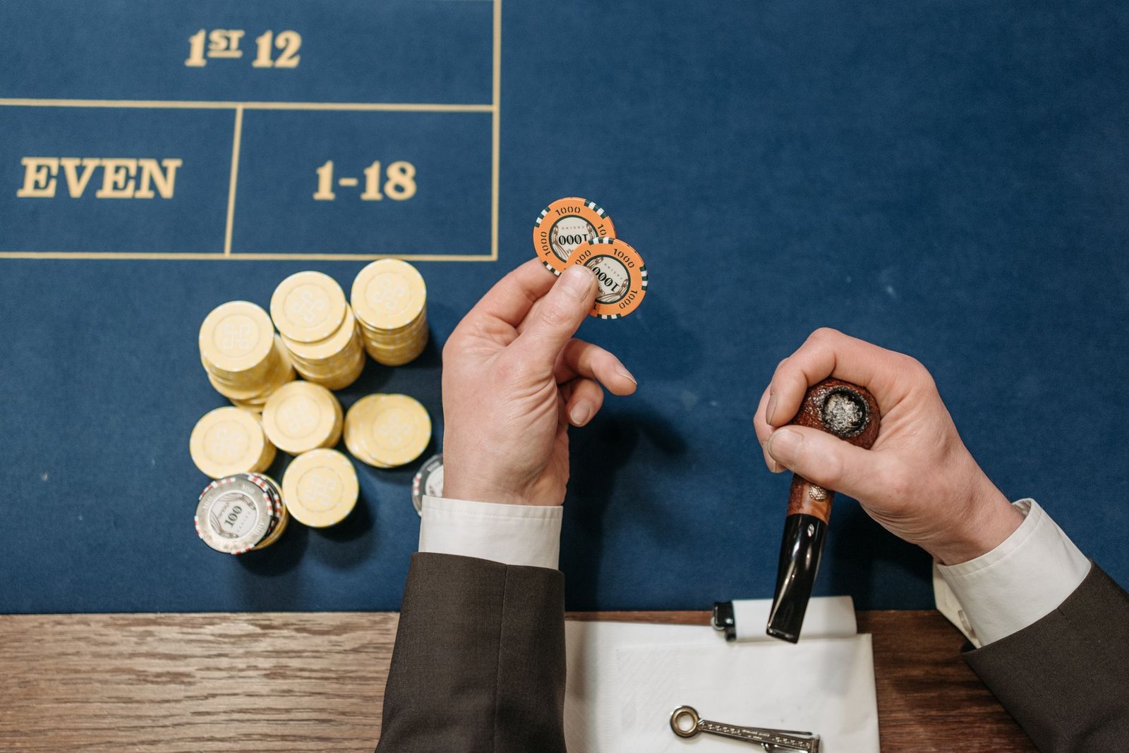 Overhead view of a casino table with poker chips and a tobacco pipe, depicting a gambling scene. — Get the Ultimate Roblox Ga