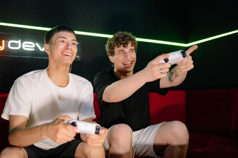 Two young men playing video games indoors, having fun and engaging with controllers. — How to Securely Deposit and Withdraw U