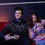 Two teenagers playing video games together, smiling and enjoying the moment indoors. — Maximize Your Gaming with Verified Cob