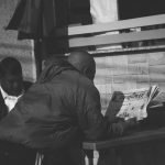 Black and white photo of a man reading a newspaper at an outdoor café in Pokhara, Nepal. — Top crypto casino